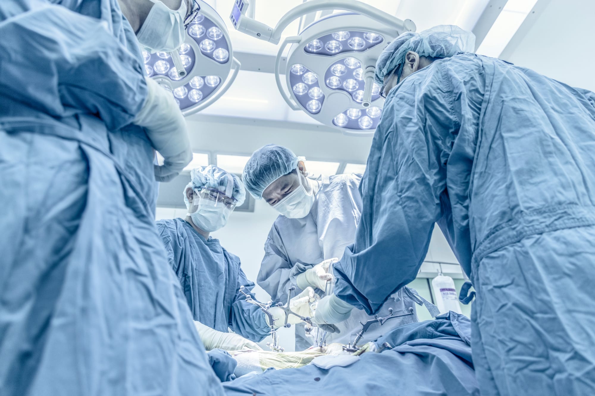 Team of orthopedic surgeons operating on a patient.